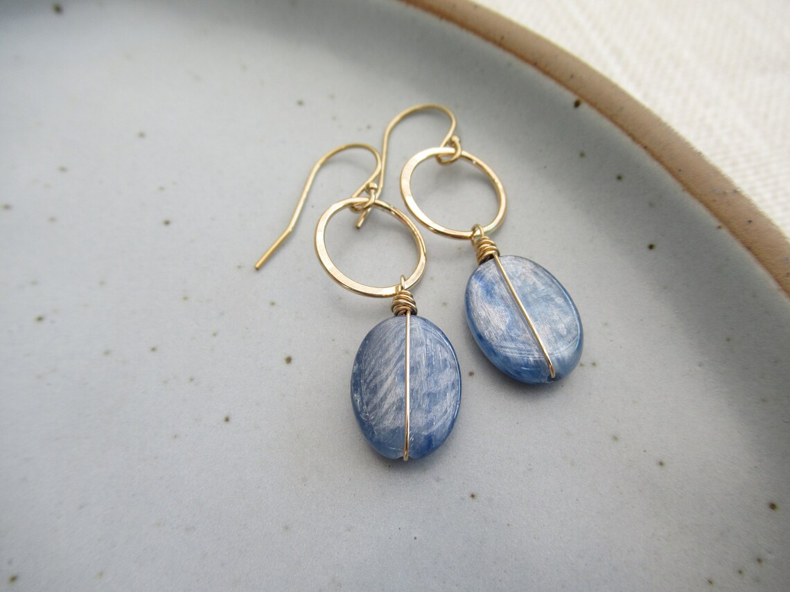 Denim blue earrings, Smooth oval wire wrapped kyanite stones drop from gold hoops, Modern geometric circles, Casual gold dangle earrings