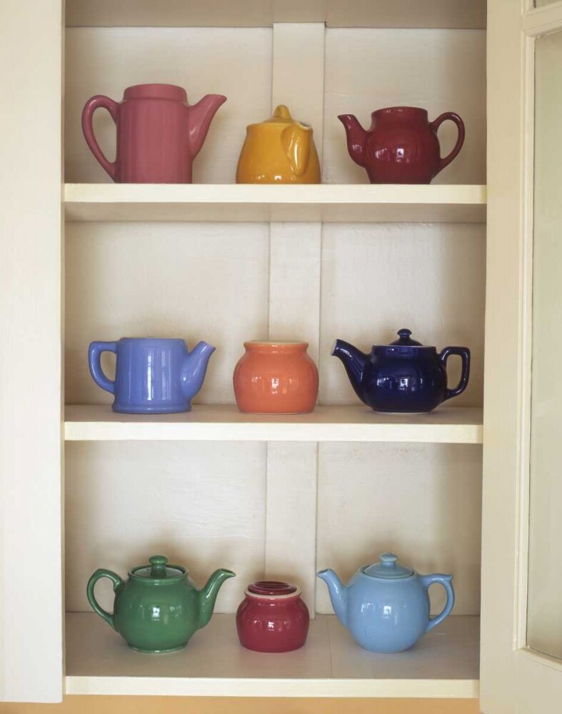 Antique ceramic teapots and sugar bowls in cupboard by Steve Terrill - Item # VARPDXUS52BJA0008