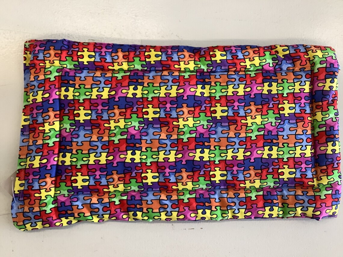 product name is Autism awareness  puzzle piece  multi colored Cuddle mat crate pad travel bed reversible