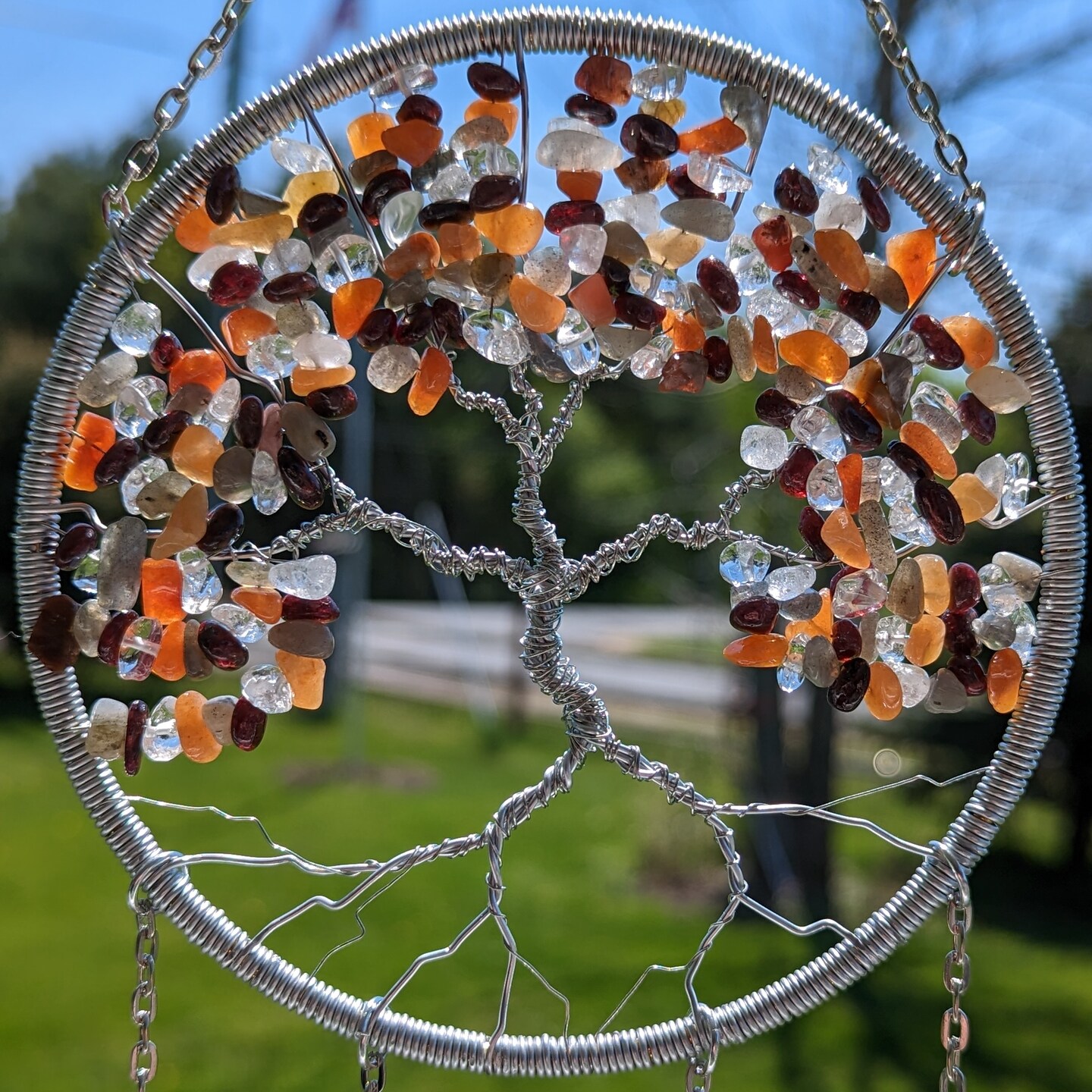 product name is Seasonal Fall Autumn Tree of Life Crystal Sun Catcher- Handmade Light Catcher Window Ornament with Garnet, Red Agate and Labradorite
