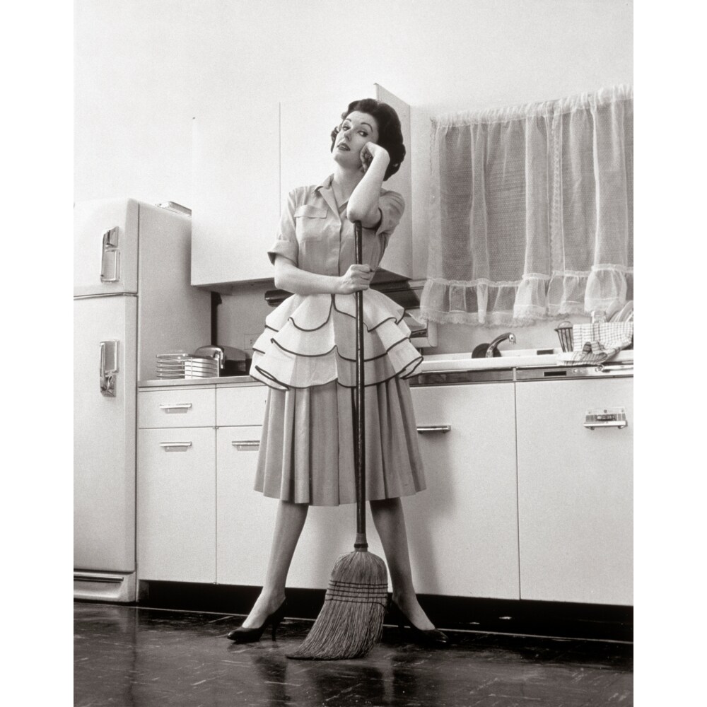 Posterazzi 1950s Woman Housewife Standing In Kitchen Leaning On Broom Poster Print By Vintage Collection
