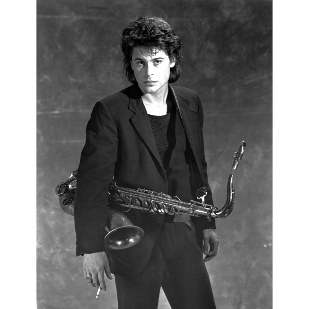 Posterazzi Rob Lowe carrying a saxophone Photo Print