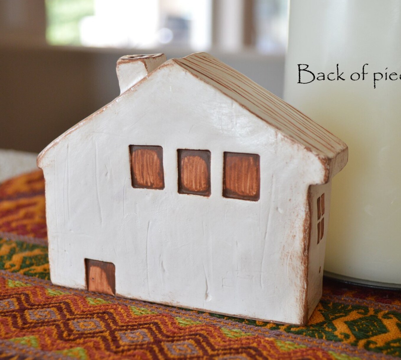 Clay house with words love lives here house text on house tabletop