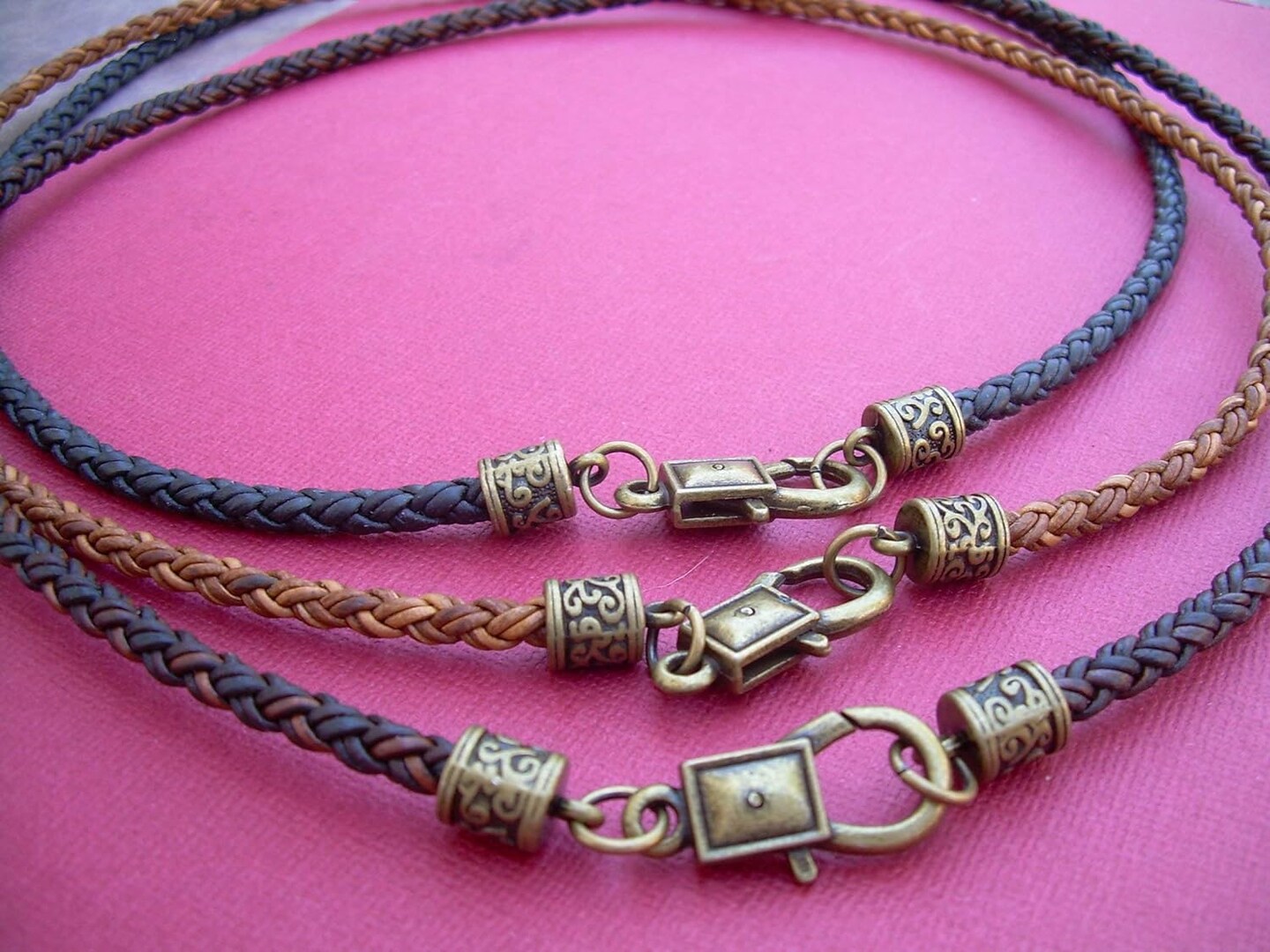 product name is Braided Leather Necklace with Bronze Toned Tooled End Caps and Lobster Clasp