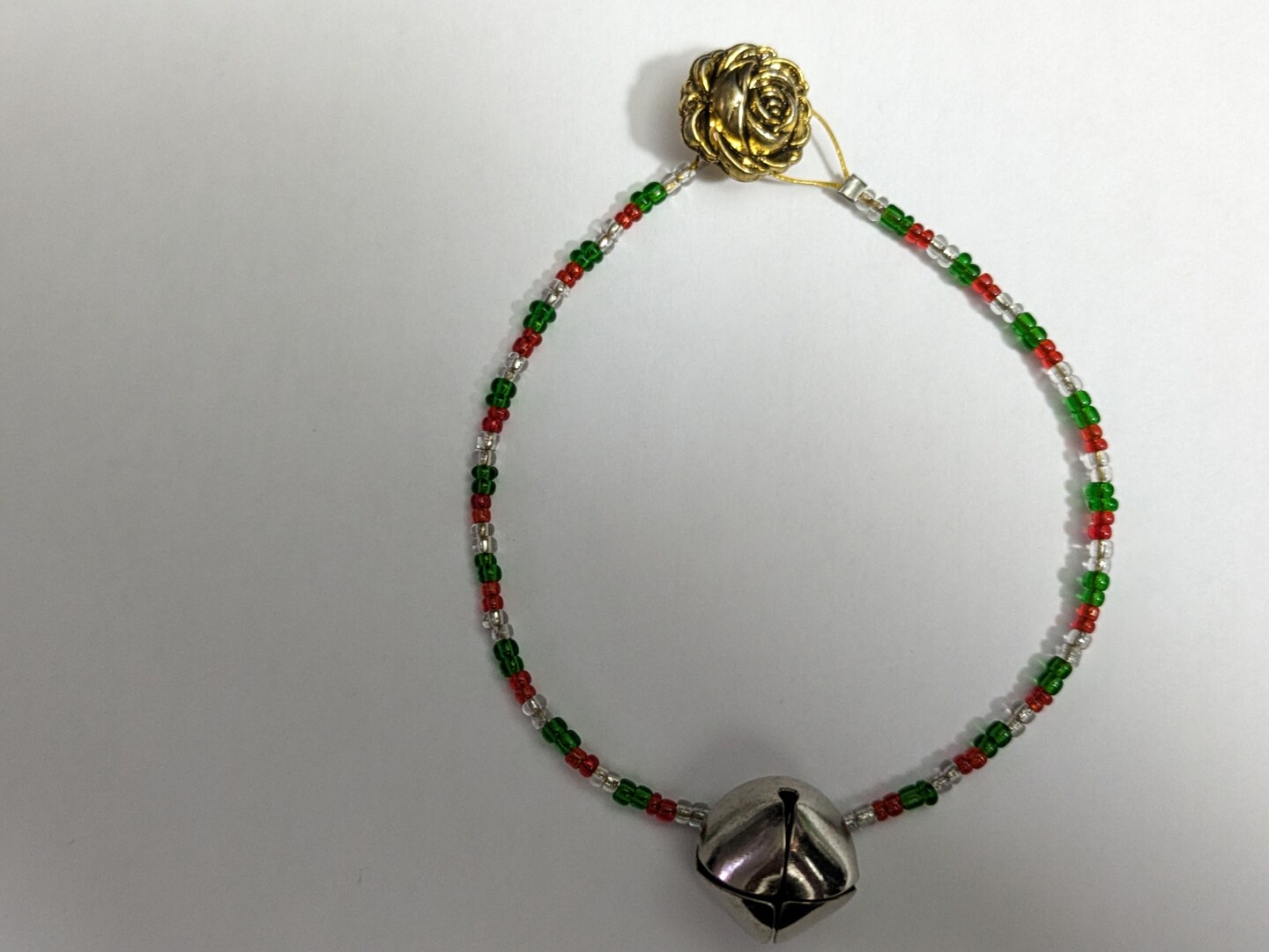 Jingle Bell Bracelet with red, green and silver seed beads. Gold flower  button clasp