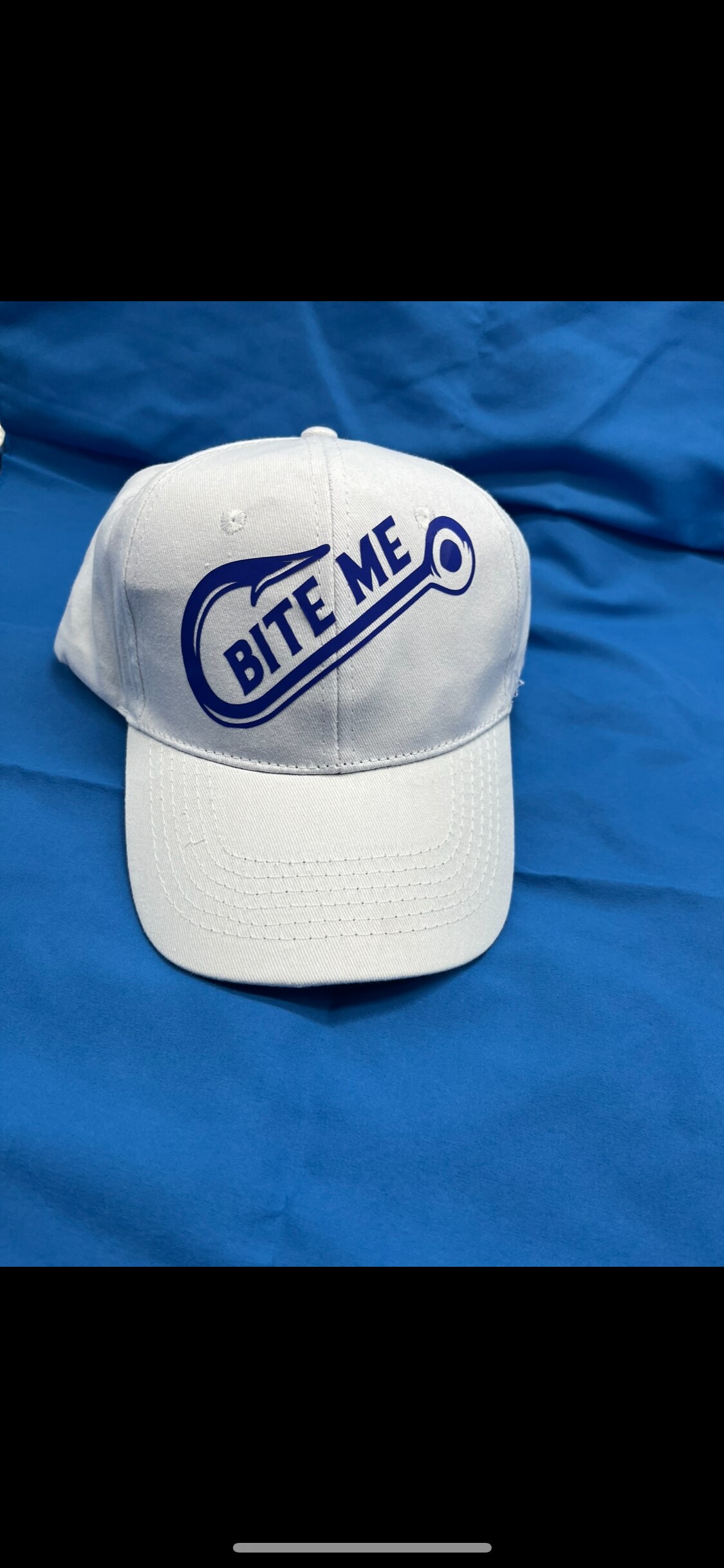 Bite me fishing hook baseball cap. Adjustable size, canvas cotton cap. Fish  hook logo and words “bite me” over hook.
