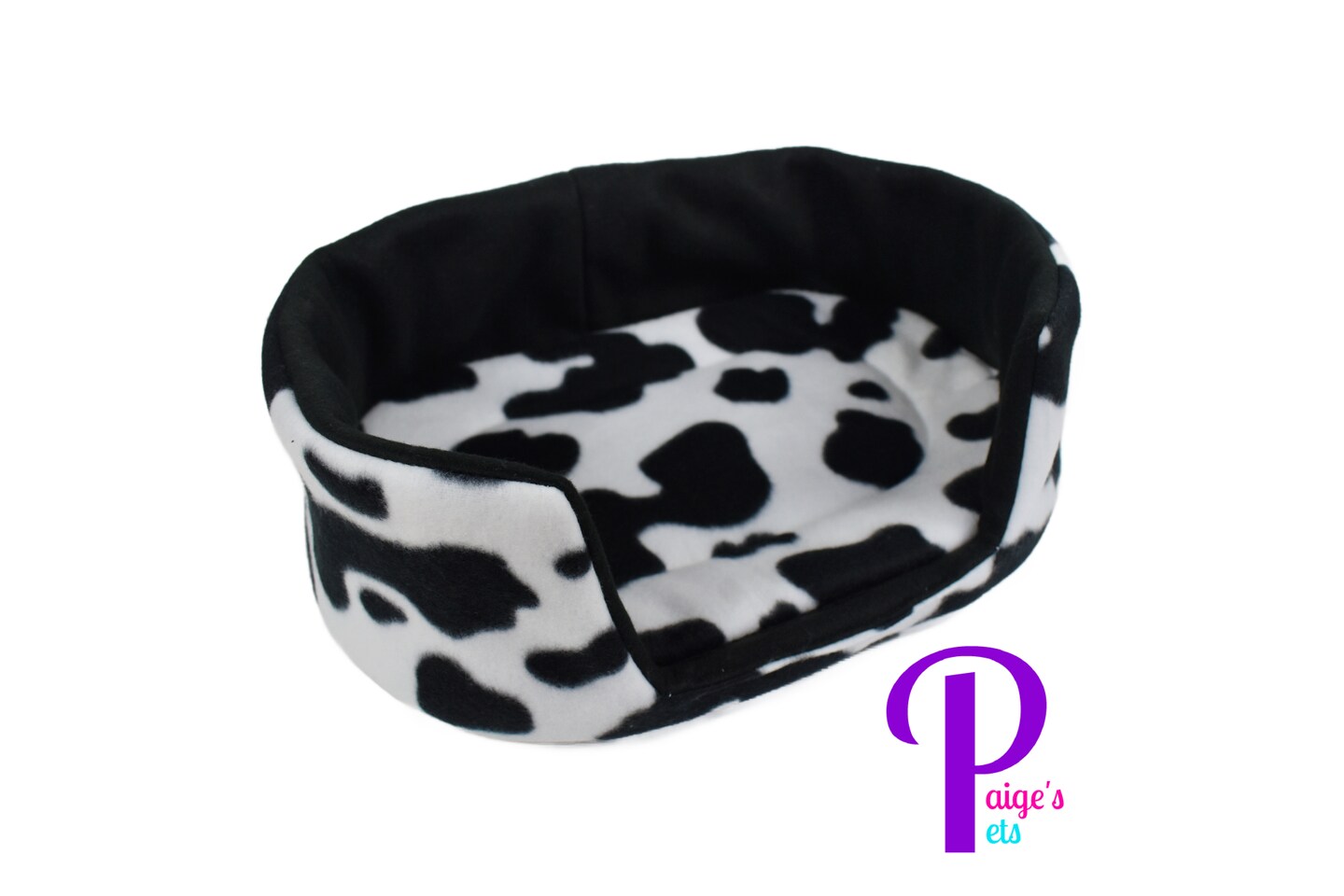 product name is Cuddle Couch,  Extra Large Cuddle Cup, Guinea Pig Bed, Ferret Bed, Hedgehog Bed, Rat Bed | Cow Print with Black