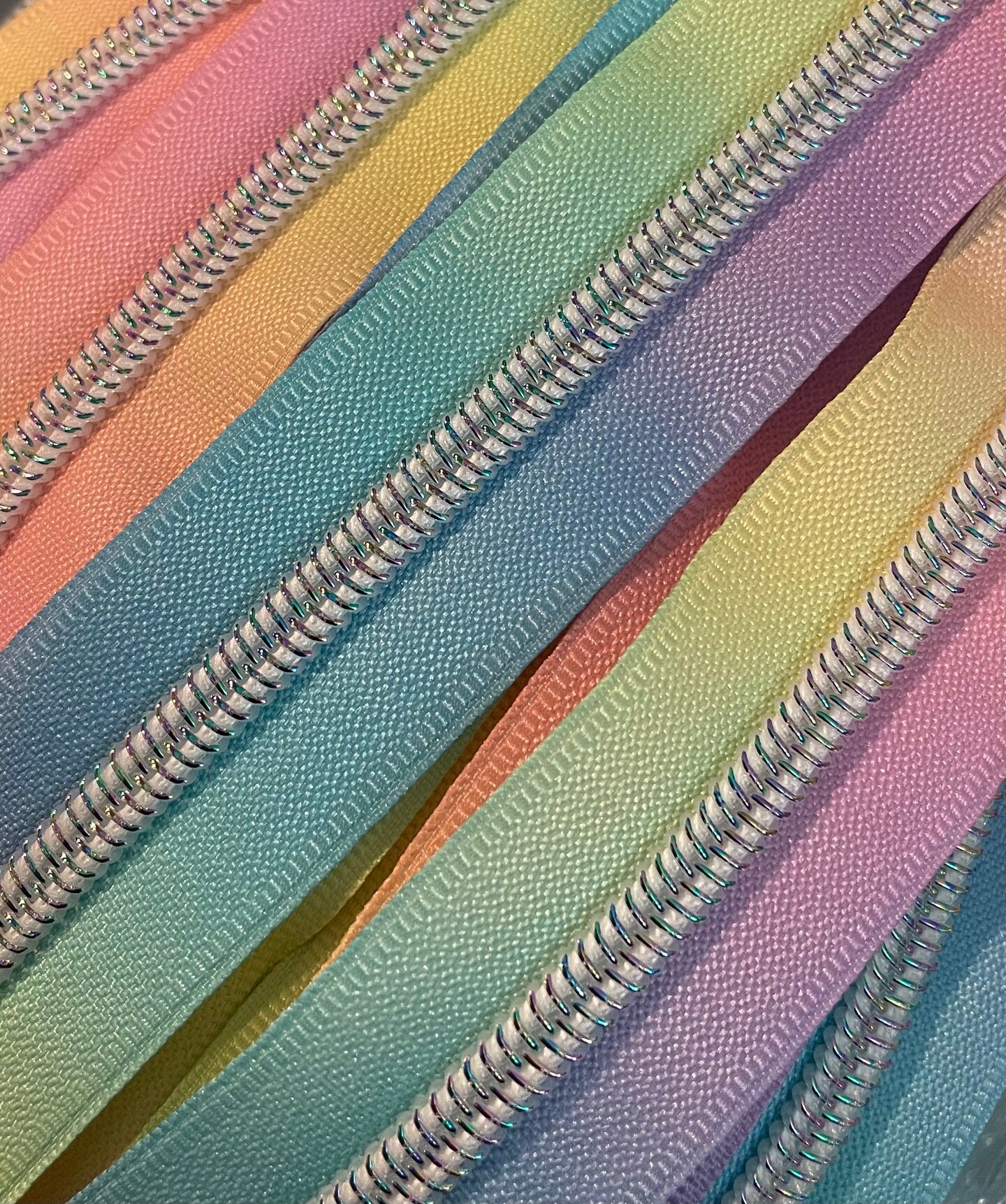 Pastel rainbow zipper tape with iridescent teeth