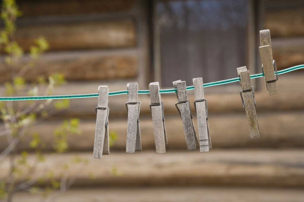MT, Clothes pins on a clothesline by a log cabin by Don Paulson - Item # VARPDXUS27BJA0070