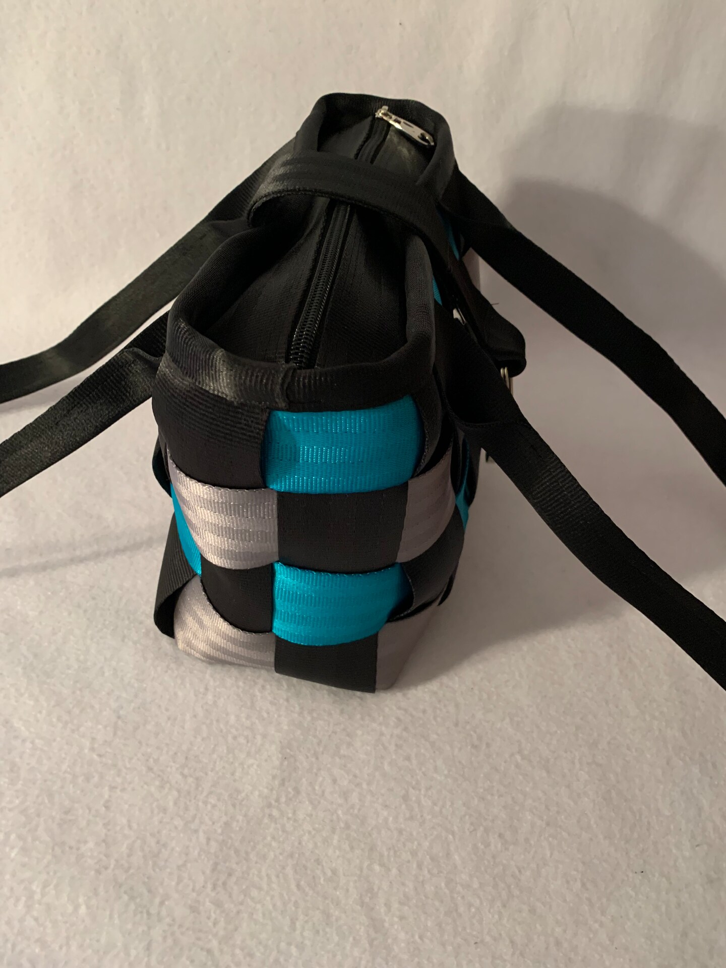 Weaved Seat Belt Purse in black, silver and turquoise with zipper