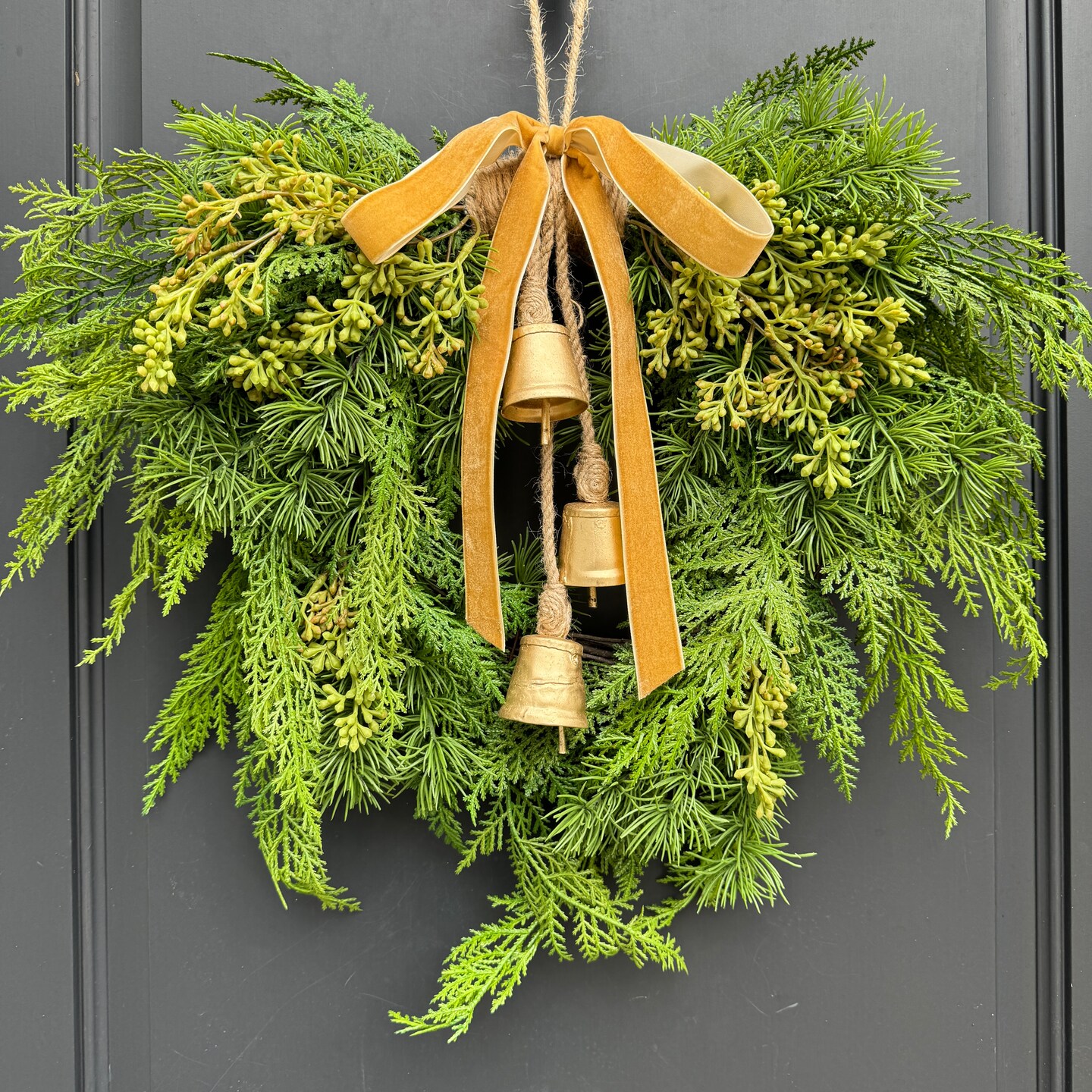 Winter Cedar Greenery Wreath with Bells | MakerPlace by Michaels