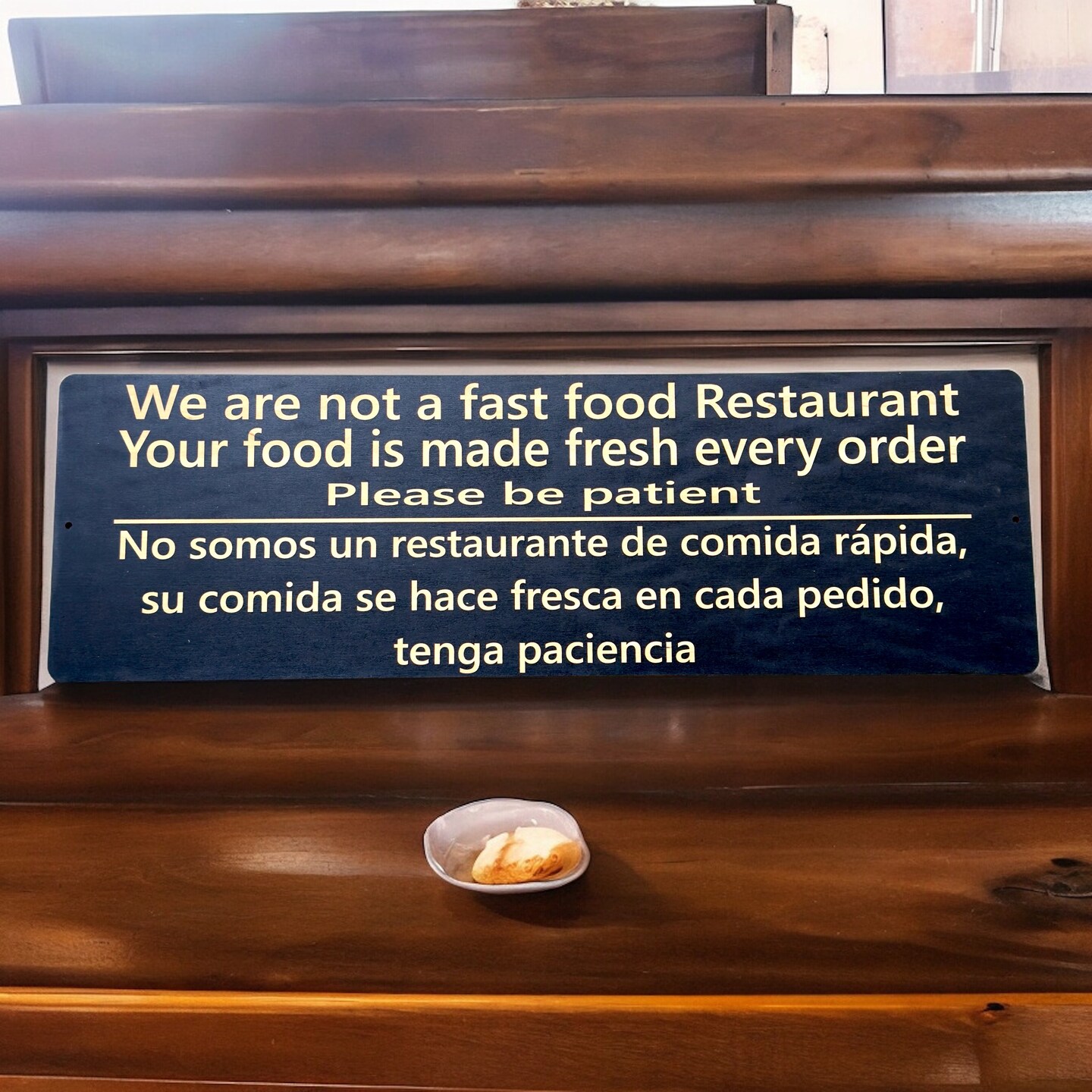 Sign - English &#x26; Spanish - We are not a fast food restaurant Please Be Patient