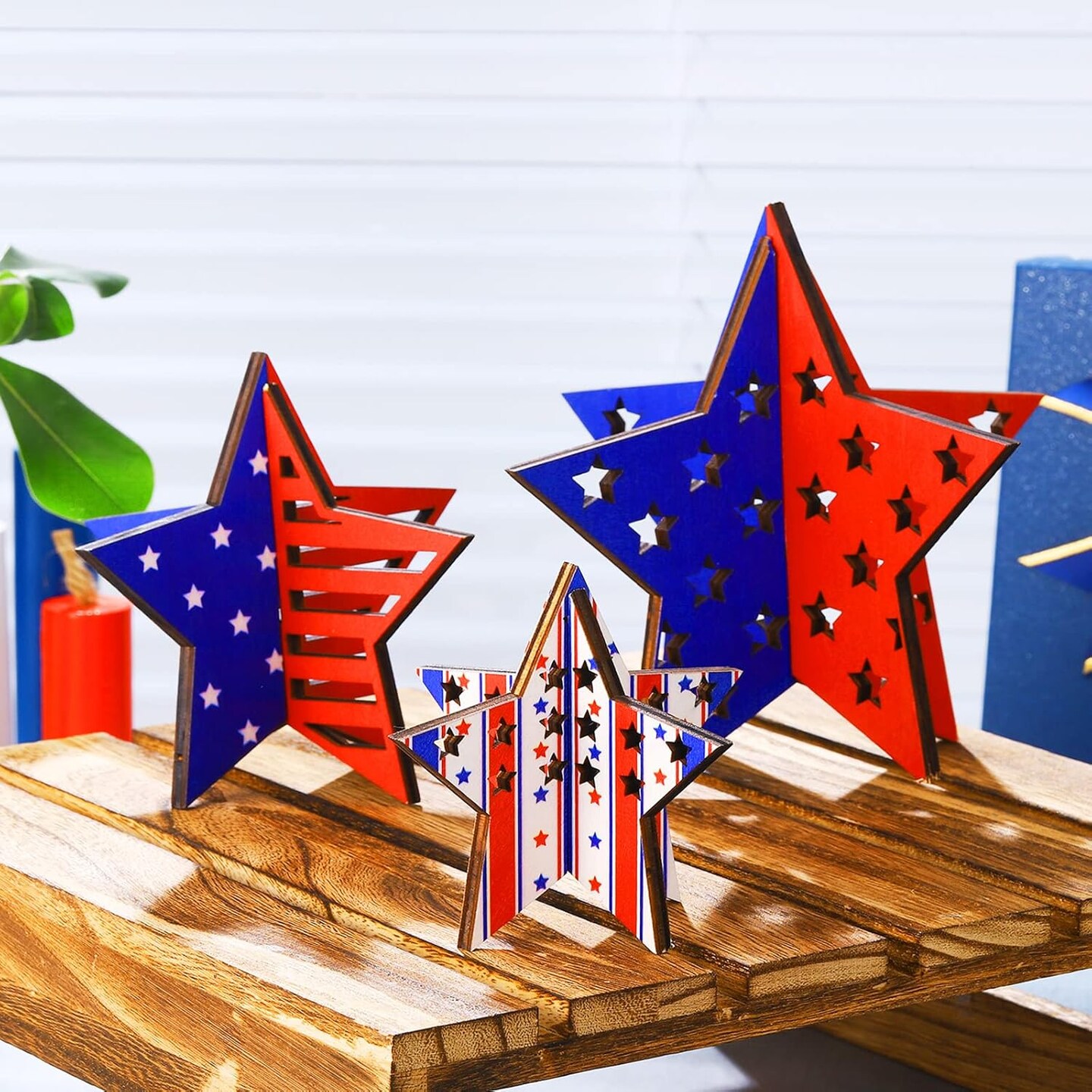 12-piece set of patriotic wooden star decorations featuring red, white, and blue designs, ideal for tiered trays, tables, shelves, and home or office décor to celebrate Independence Day and Memorial Day.