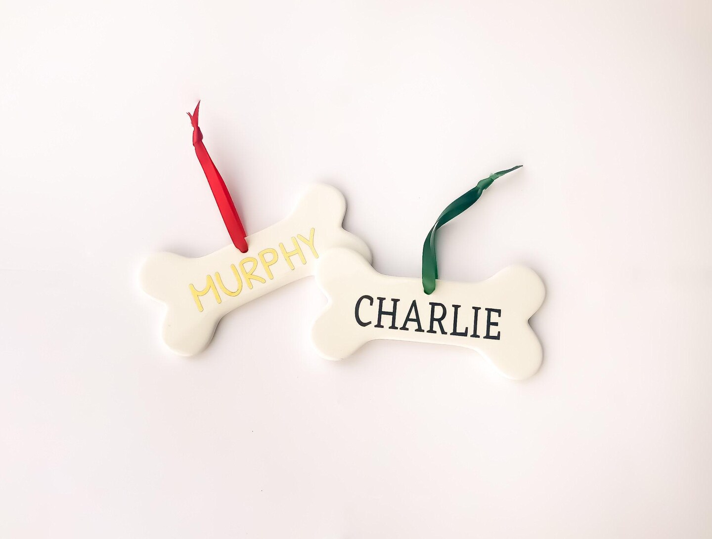 product name is Personalized Pet Ornament - Unique Ceramic Dog Bone with Calligraphy Pet's Name - Dog Christmas Gift, Pet Gifts, Dog Lover Gifts, Under 20