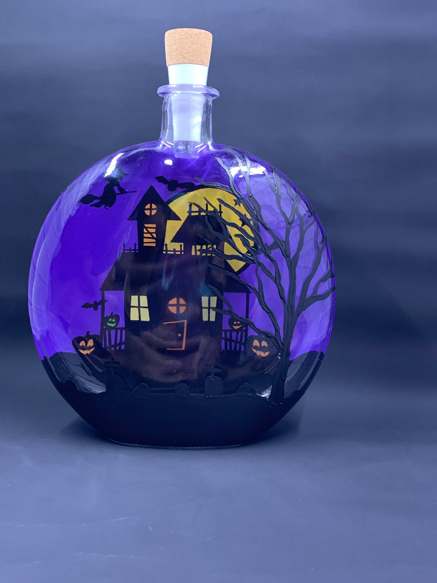 Glass haunted house light up lantern with witch flying on broom over a large full moon in