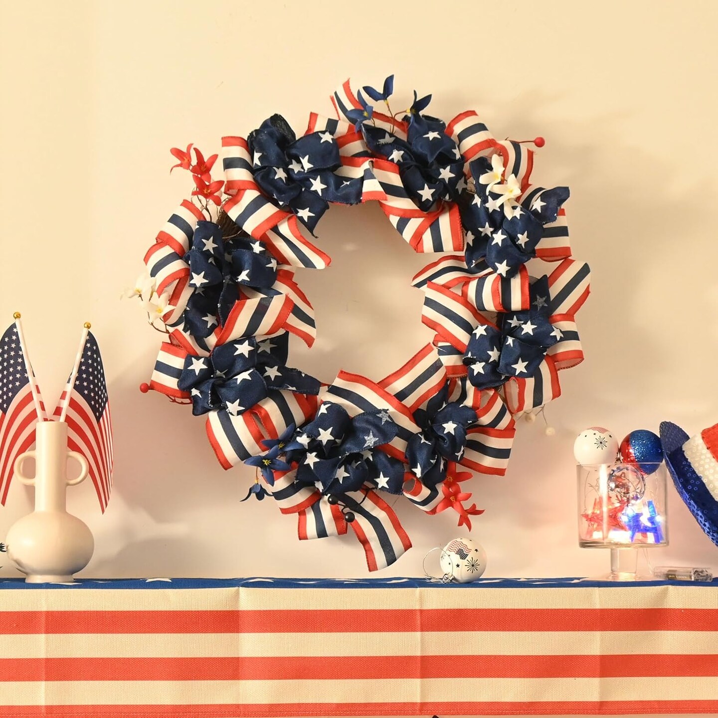 24-inch patriotic wreath in red, white, and blue with a burlap bow and built-in lights, designed for front doors or home décor, perfect for Independence Day, Memorial Day, and other national holiday celebrations.