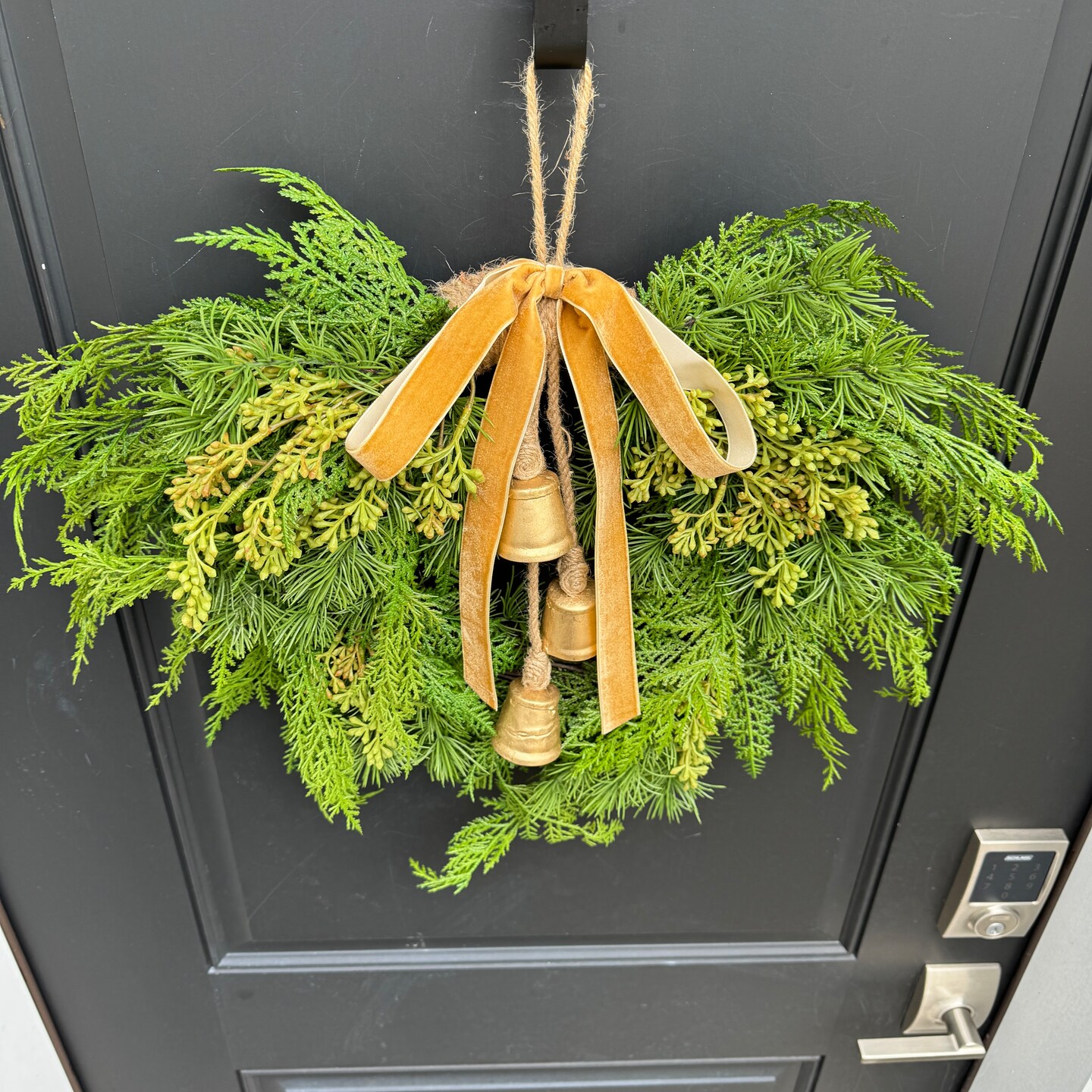 Winter Cedar Greenery Wreath with Bells | MakerPlace by Michaels