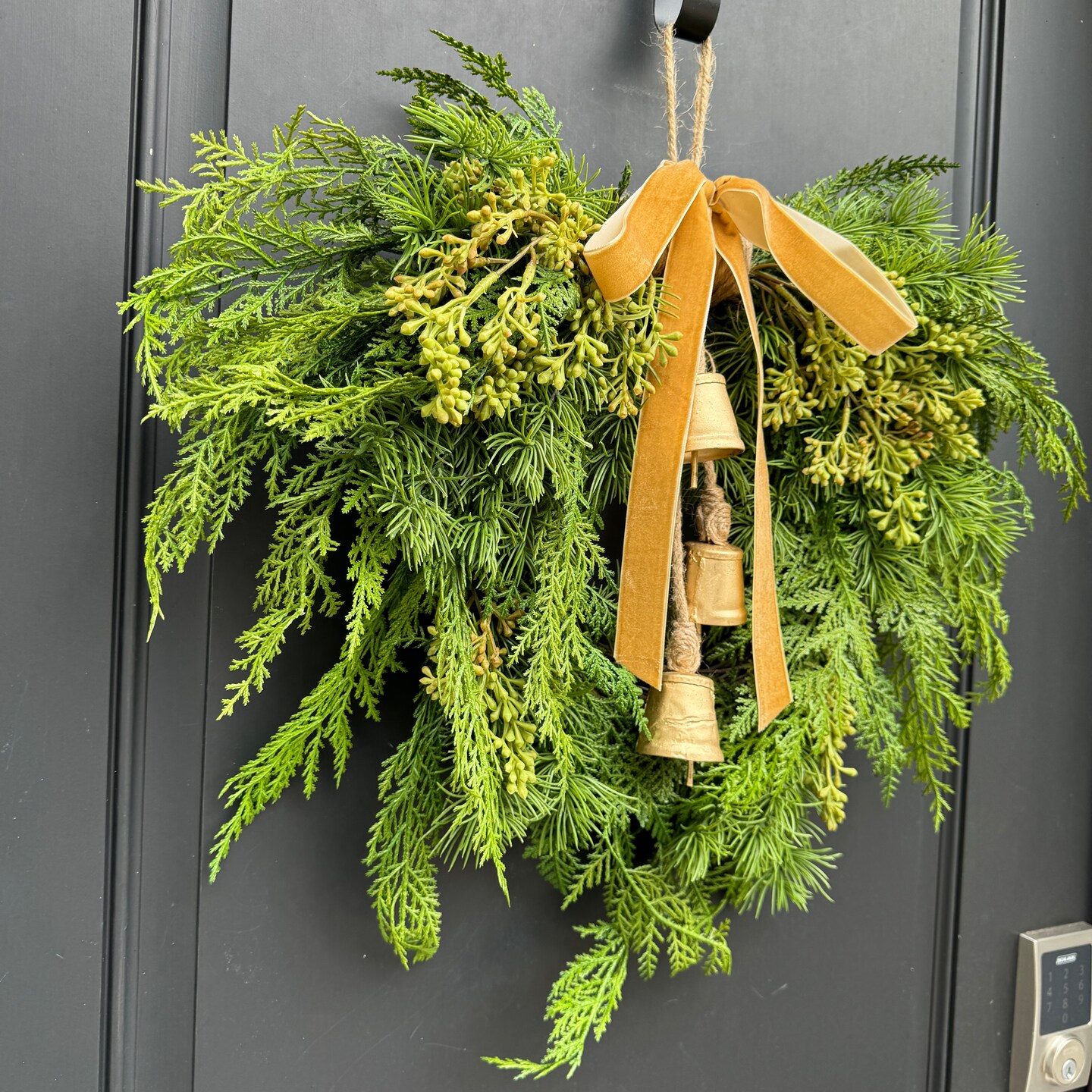 Winter Cedar Greenery Wreath with Bells | MakerPlace by Michaels