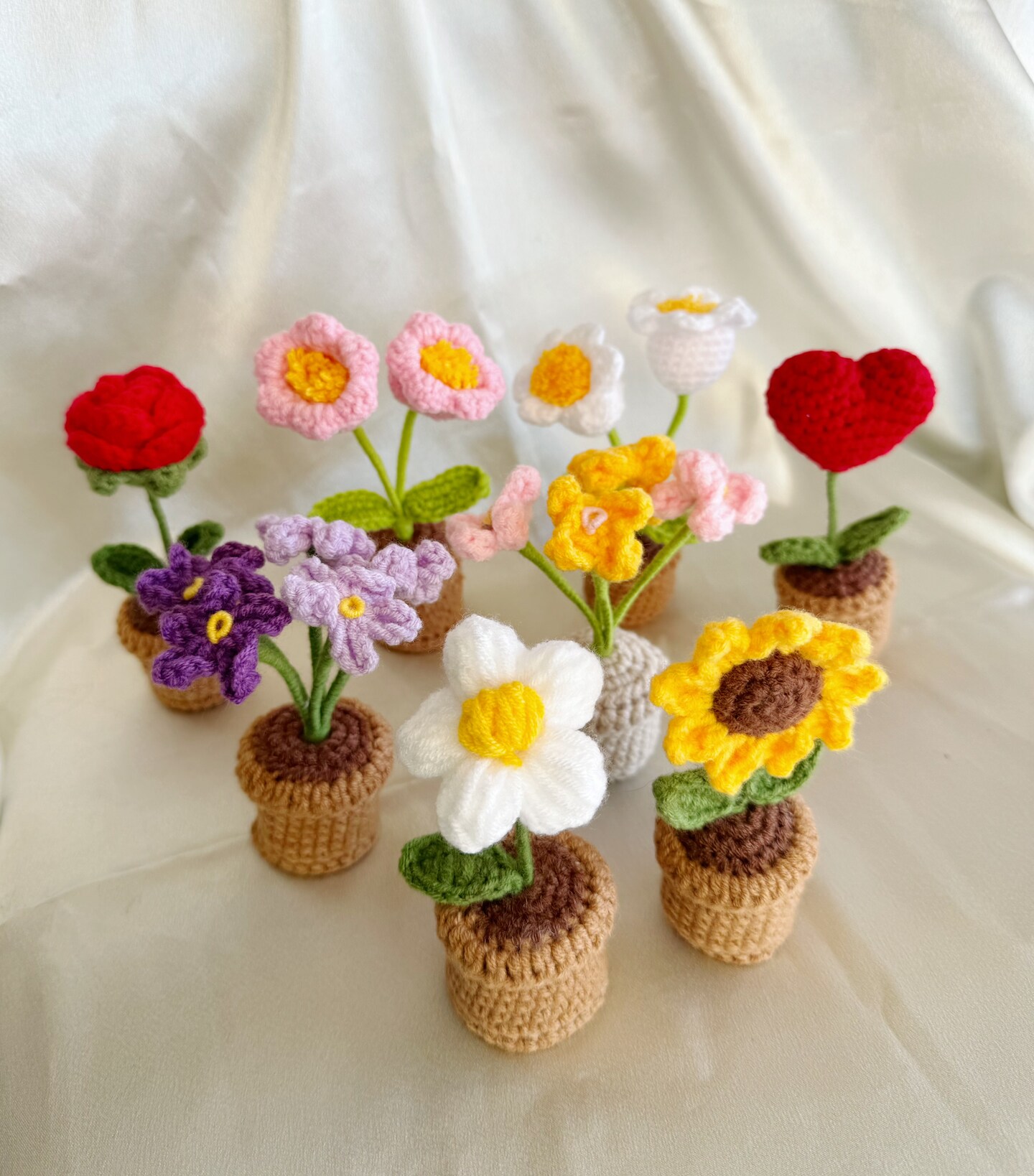 product name is Cute Crochet flower in pot, Mini Pot-Knitted, handmade flower, Sunflower, Rose, Myosotis, Puff flower, Lily of the Valley, home decoration