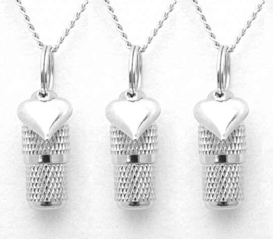 product name is Set Of Three Faceted Steel PET CREMATION URNS with Hearts on 24" Ball Chain Necklaces - Includes Velvet Pouch and Fill Kit