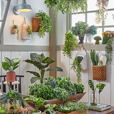 room filled with faux greenery, plants and hanging vines