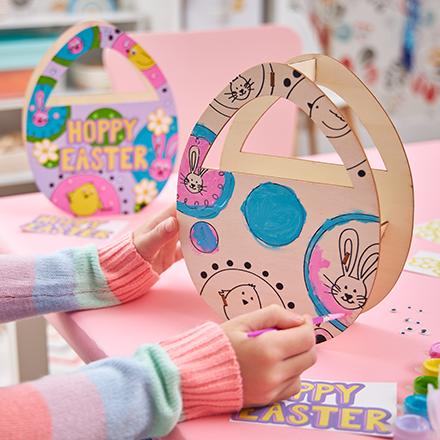 child's hands making wood Easter craft