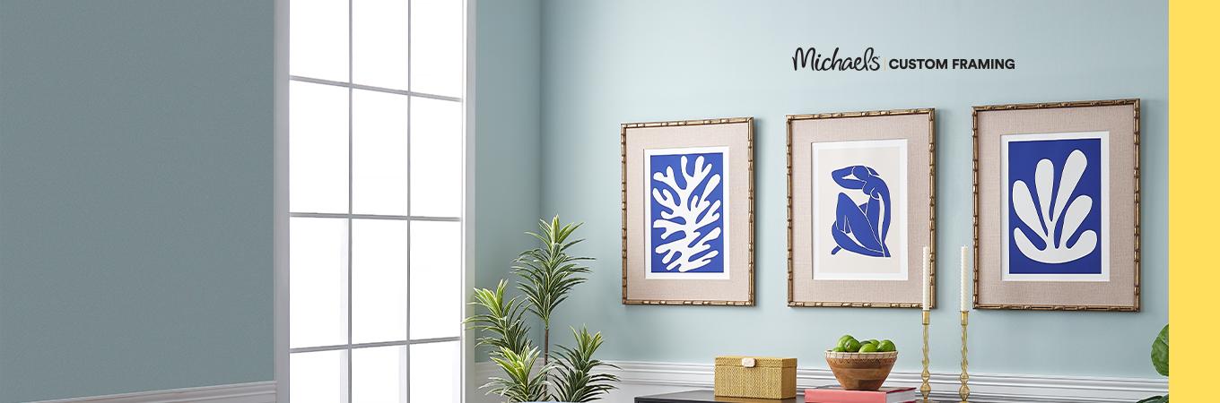 blue room with three blue & white ink art prints in gold frames