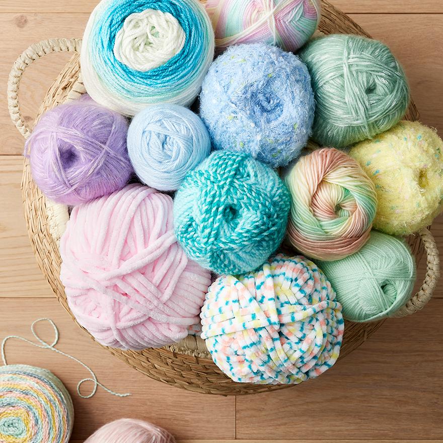 pastel yarn skeins in wicker basket