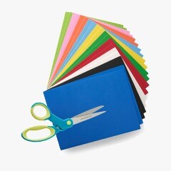 scissors on top of fanned stack of colorful papers