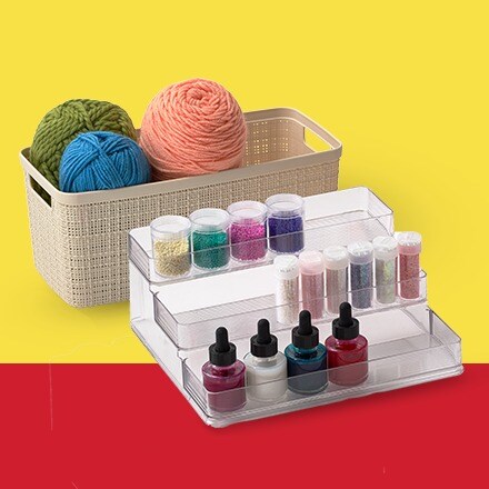 yarn in tan bin and clear organizer on yellow and red background