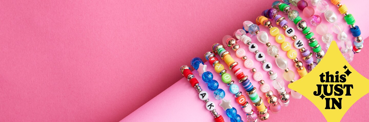 colorful bead bracelets on pink background with This Just In logo