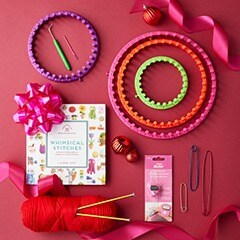 Knitting items sitting on a red background