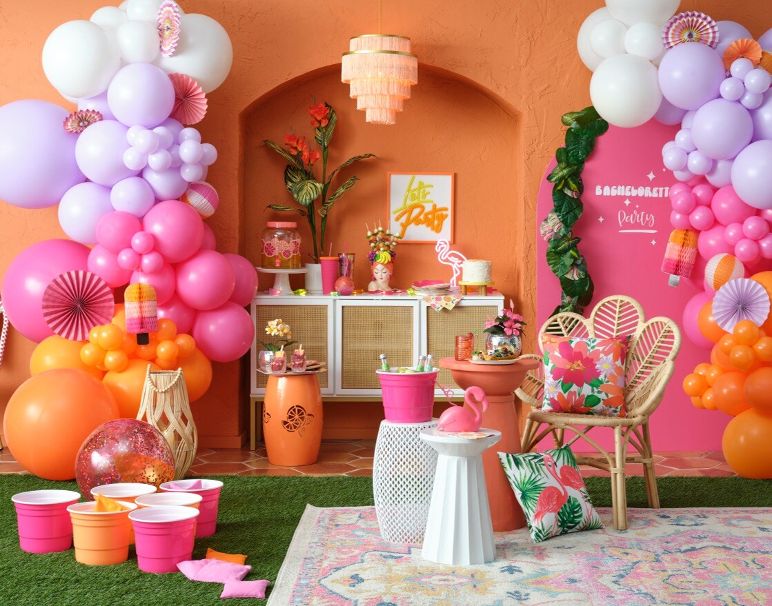 pink and orange pool party scene with balloons