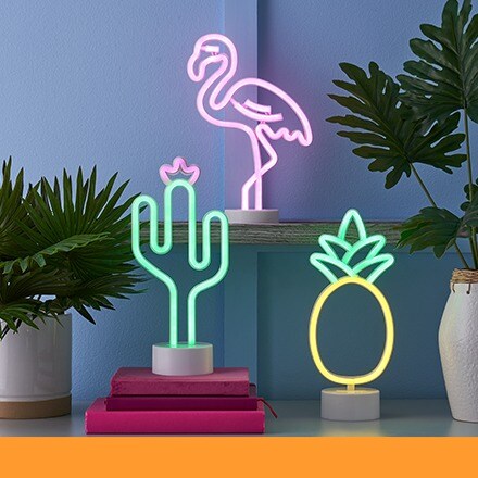 neon table lights of a flamingo, cactus and pineapple