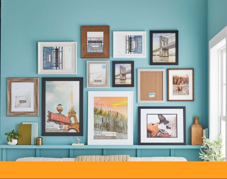 gallery wall of frames on teal wall