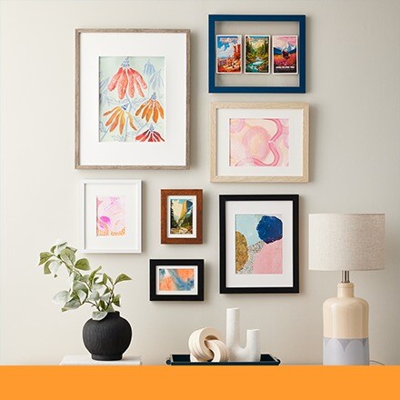 gallery wall of frames with colorful art prints