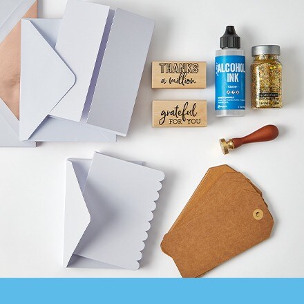 blank cards and envelopes with tags, stamps, and glitter