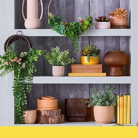shelves with variety of vases and faux greenery
