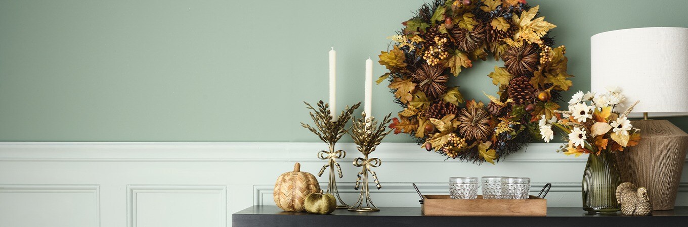 Give Thanks collection. Tabletop fall decoration items in green tones: candle holders, pumpkins, wall Floral wreath, vase and a decorative turkey.