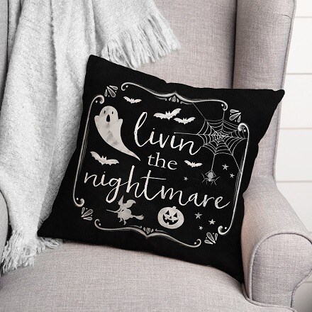 Black Pillow in a couch with a Ghost and the phrase Living the Nightmare