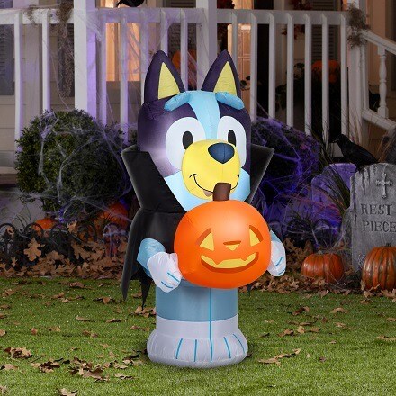 Bluey in a vampire costume with a pumpkin inflatable
