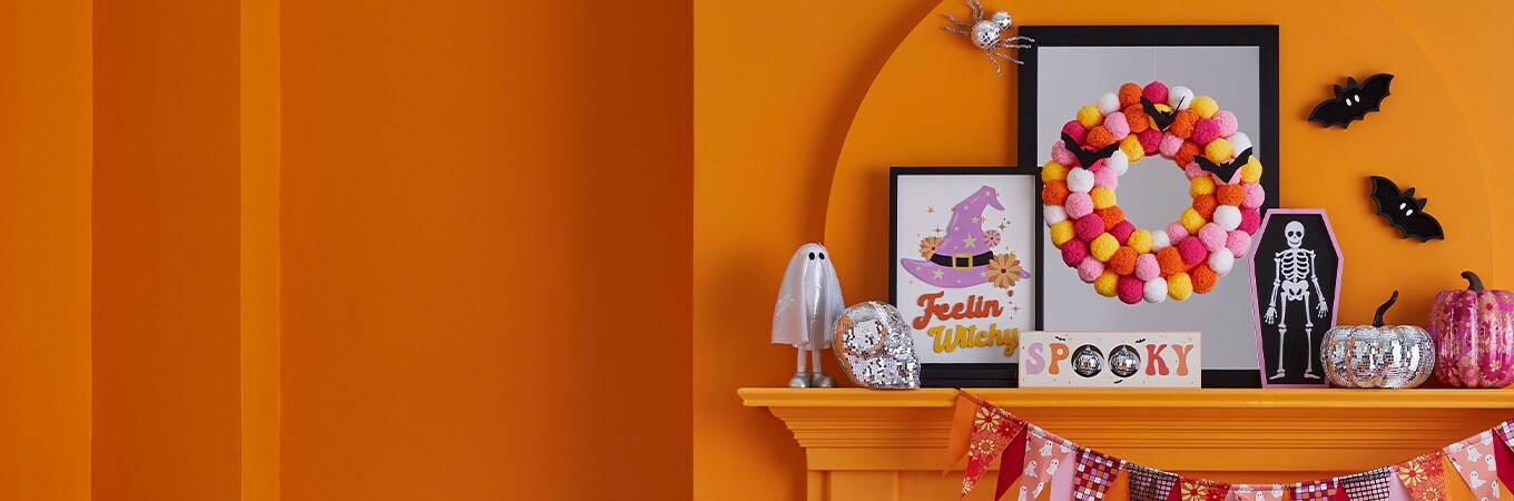 Hippie Hallow Collection: Tabletop Halloween decorations in bright pink, yellow and orange colors. Ghost, witch hat, skeleton, pumpkins.