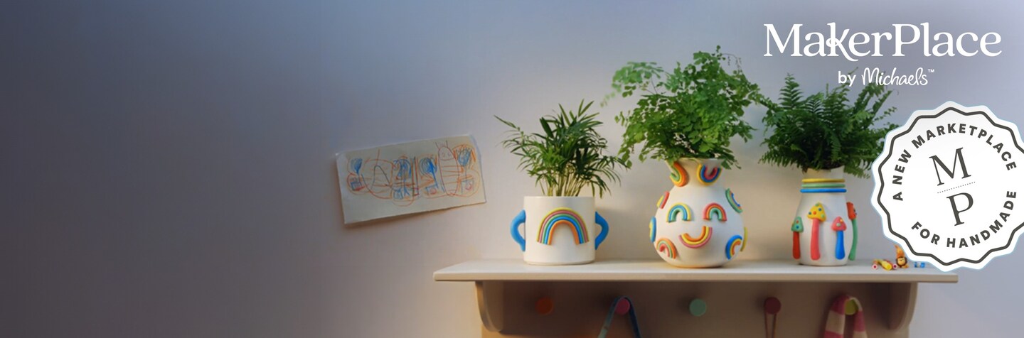3 rainbow handmade clay pots with ferns on shelf