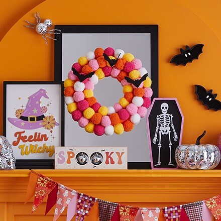 Hippie Hallow Collection: Tabletop Halloween decorations in bright pink, yellow and orange colors. Ghost, witch hat, skeleton, pumpkins.