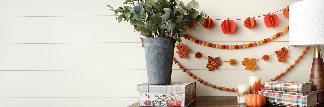 Decorative Garlands in orange, red and yellow colors with Pumpkins and Fall leaves