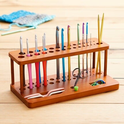 wooden tabletop store with crochet hooks and knitting needles