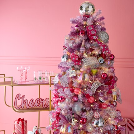A christmas tree with presents and a fireplace