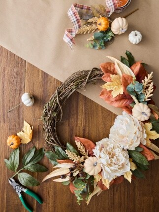 partially made grapevine wreath with faux flowers