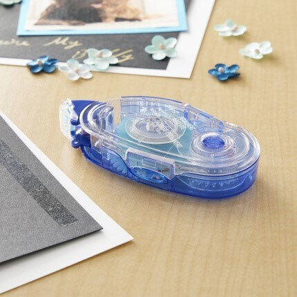 adhesive glue dots on table with cardstock