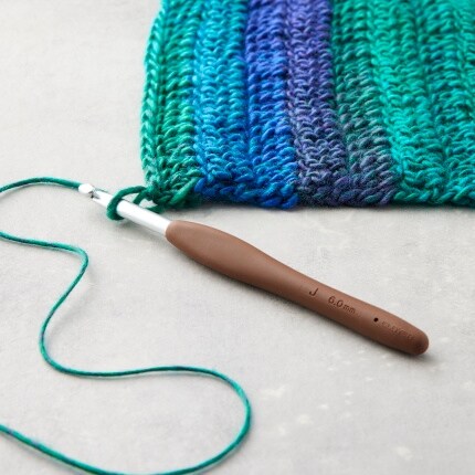 crochet hook with blue and green yarn project